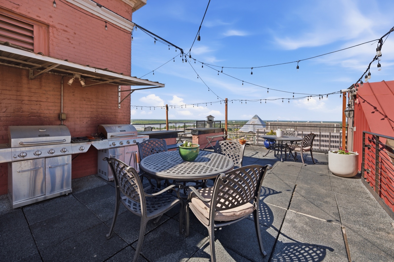 Cascade's Roof deck with string lights and grills
